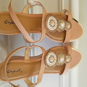 A peached coloured wedge sandals